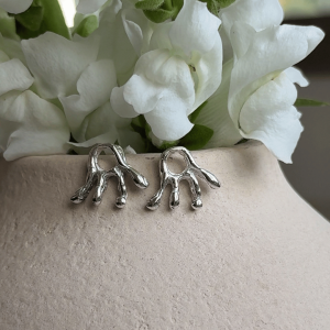 Inspired by the organic, radiant forms of the sun, the Solar Earrings are sculptural statement earrings with a raw and fluid character. Their irregular silhouette and softly textured finish give each pair an artistic, handcrafted feel that stands out while remaining delicate enough for everyday wear.